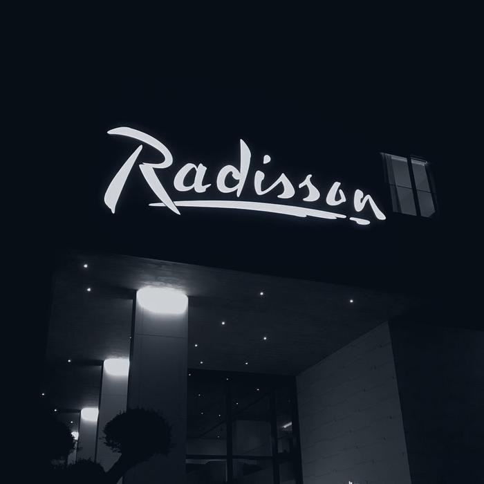 Radisson illuminated facade signage at night